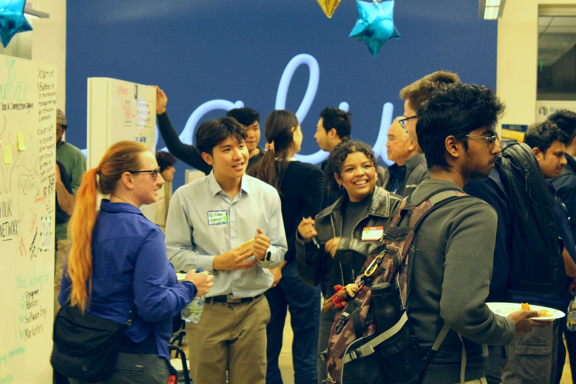 A lively networking event where people are engaged in conversations.